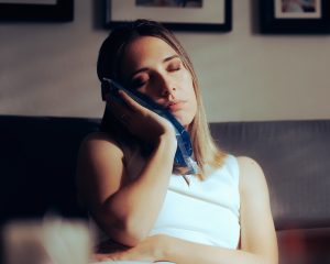 woman with an ice pack on her mouth